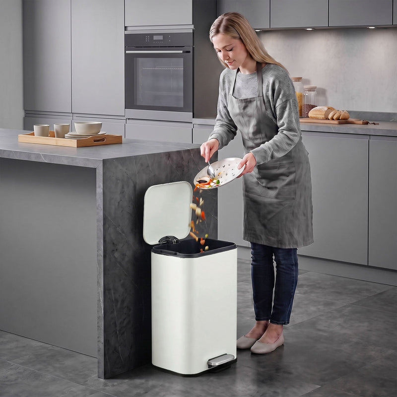 Woman scraping food into an open 20L pedal bin in a modern kitchen