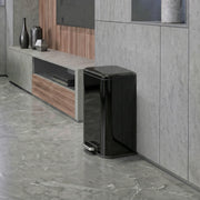20L pedal bin standing beside a TV unit in a living room