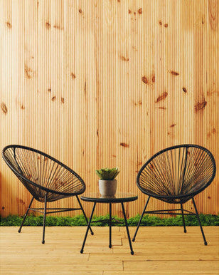 Black rattan 3 piece bistro set styled indoors in a conservatory