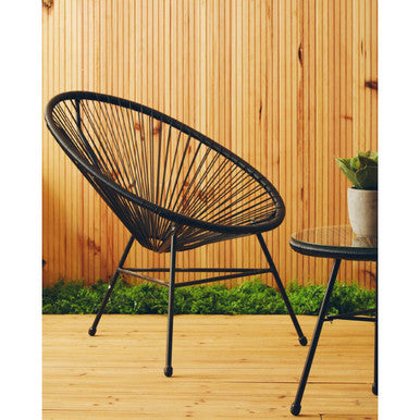 Black rattan 3 piece bistro set styled in a living space