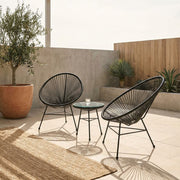 Black rattan 3 piece bistro set in an outdoor garden setting