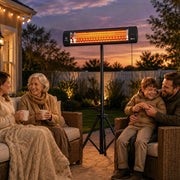 Family and friends relaxing under the patio heater on a garden patio at dusk