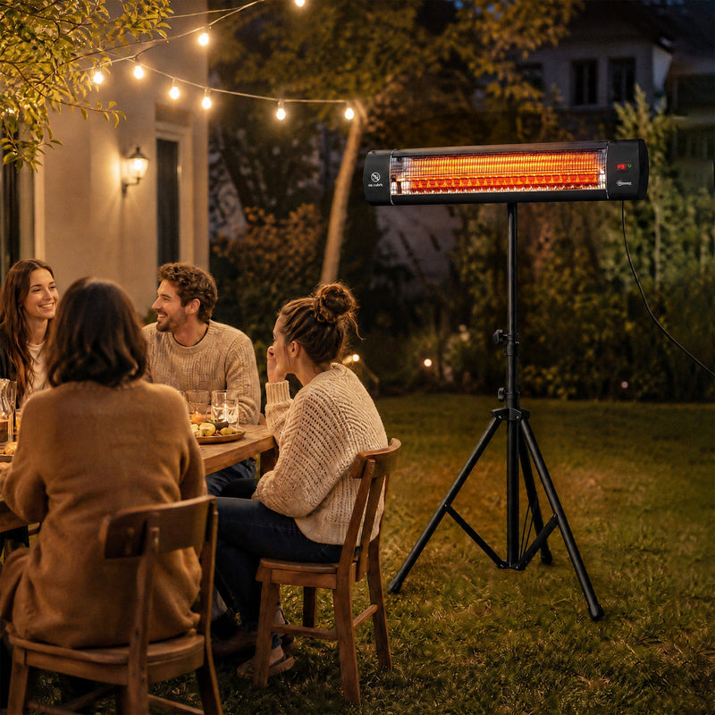 Friends dining outdoors in the evening warmed by the patio heater on its tripod