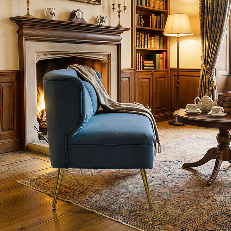 Blue sofa in a cozy living room with a fireplace and bookshelf.