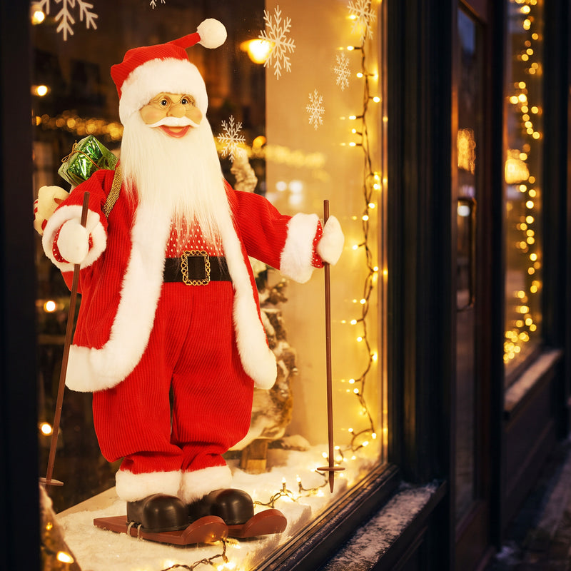 Skiing Santa figure in a window with warm fairy lights