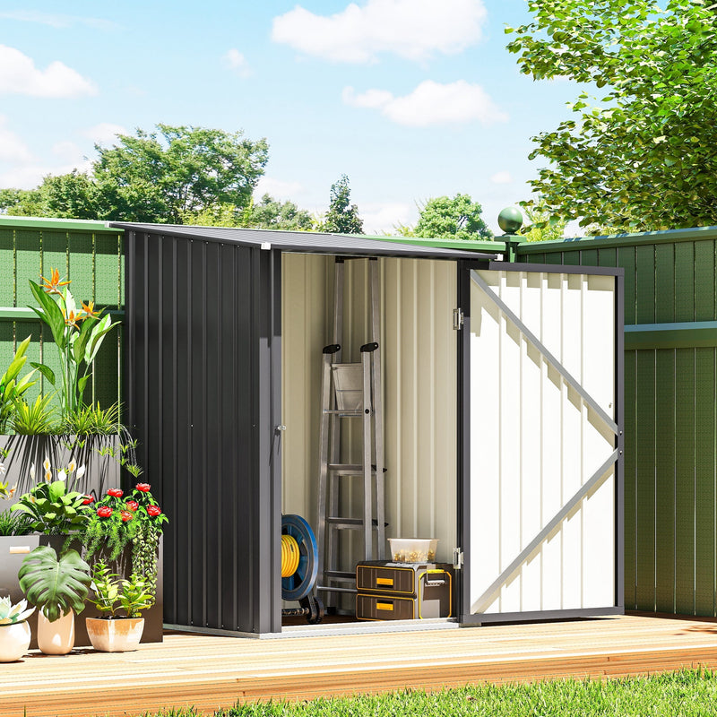Shed door open beside potted plants showing a ladder and storage boxes inside