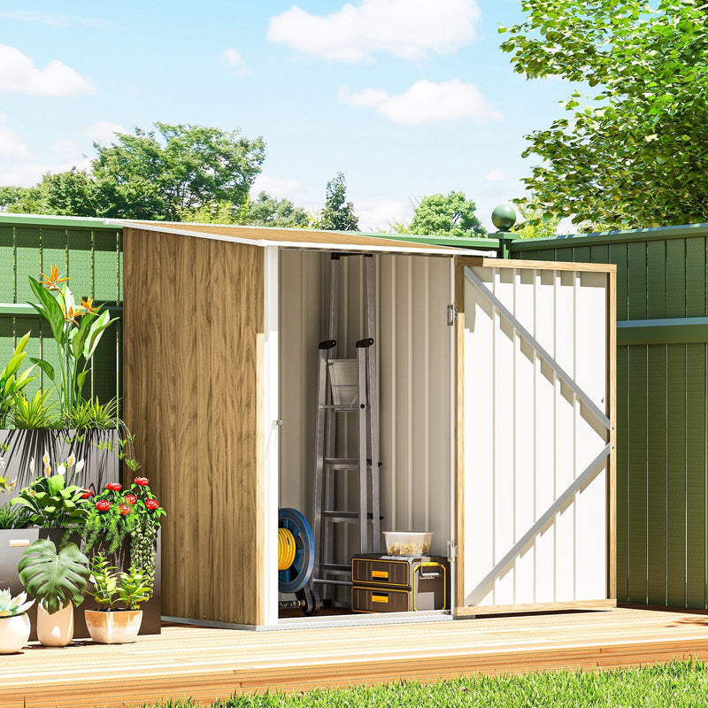 Shed door open beside potted plants showing a ladder and storage boxes inside