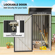 Shed door open showing the latch and 73 cm door width with garden tools inside