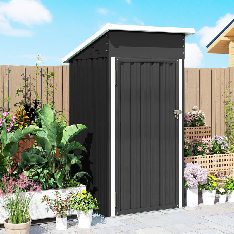 Closed dark grey metal shed on a patio with plants