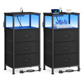 Two ink black bedside tables with three fabric drawers each and blue LED lit open shelves