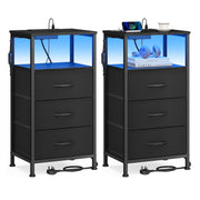 Two ink black bedside tables with three fabric drawers each and blue LED lit open shelves