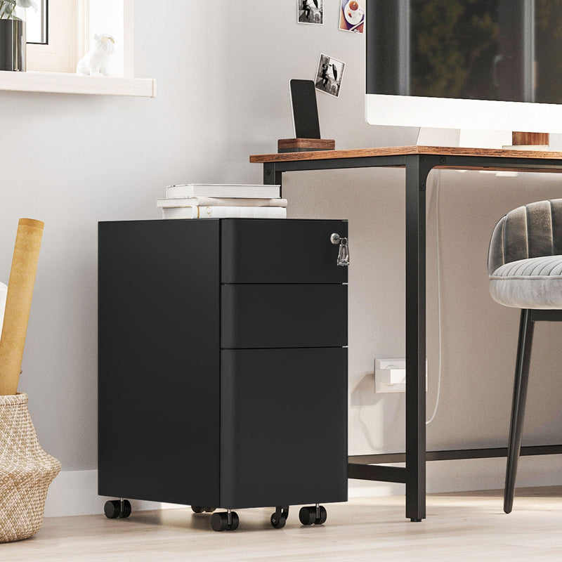 Black filing cabinet beside a desk in a bright room with a grey chair