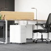 White filing cabinet tucked under a desk in a grey carpeted office