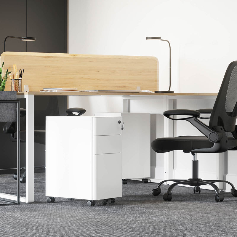 White filing cabinet tucked under a desk in a grey carpeted office