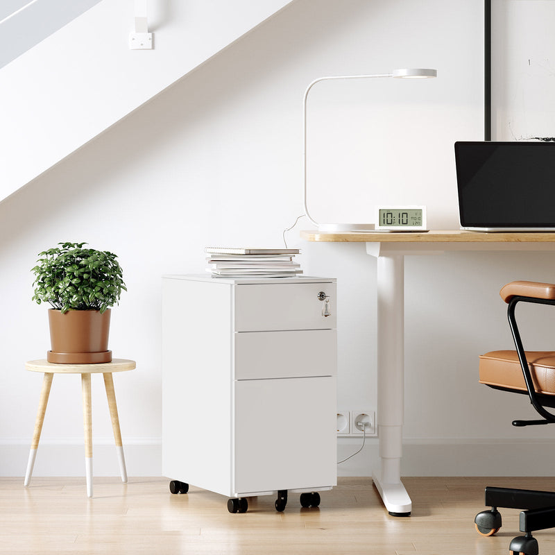 White file cabinet beside a height adjustable desk in a home office, next to a plant on a stool