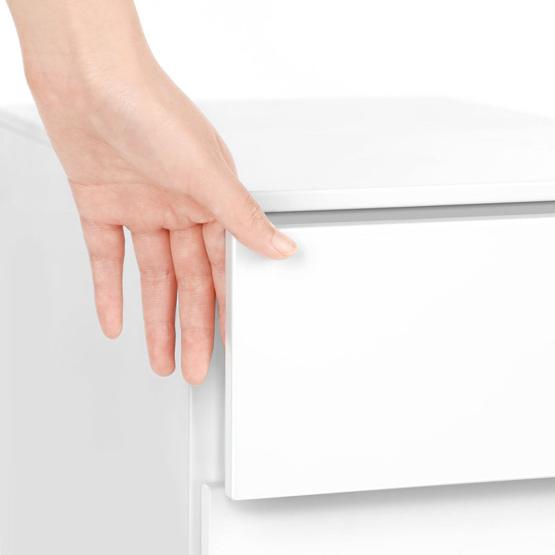 Hand reaching into the recessed edge pull beneath the file cabinet's top panel to open a drawer