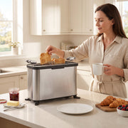 Woman lifting toast from the appliance stood upright as a long slot toaster