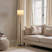 Lifestyle living room shot of the lamp switched on beside a cream sofa