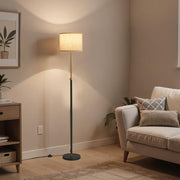 Lifestyle corner shot of the lamp illuminating a living room beside a sofa and side table