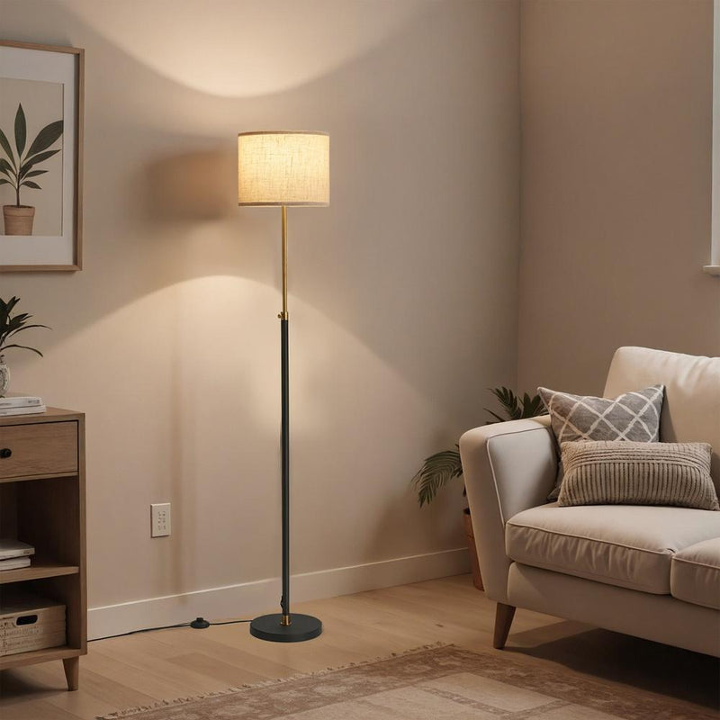 Lifestyle corner shot of the lamp illuminating a living room beside a sofa and side table