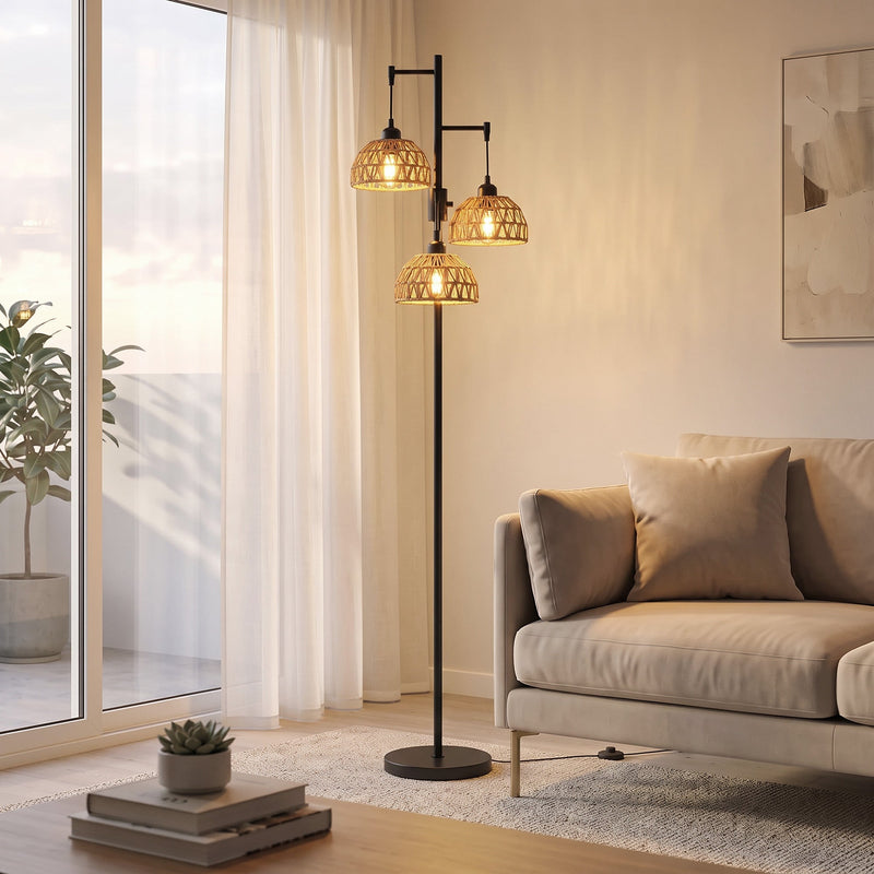3-light floor lamp glowing beside a sofa and curtains
