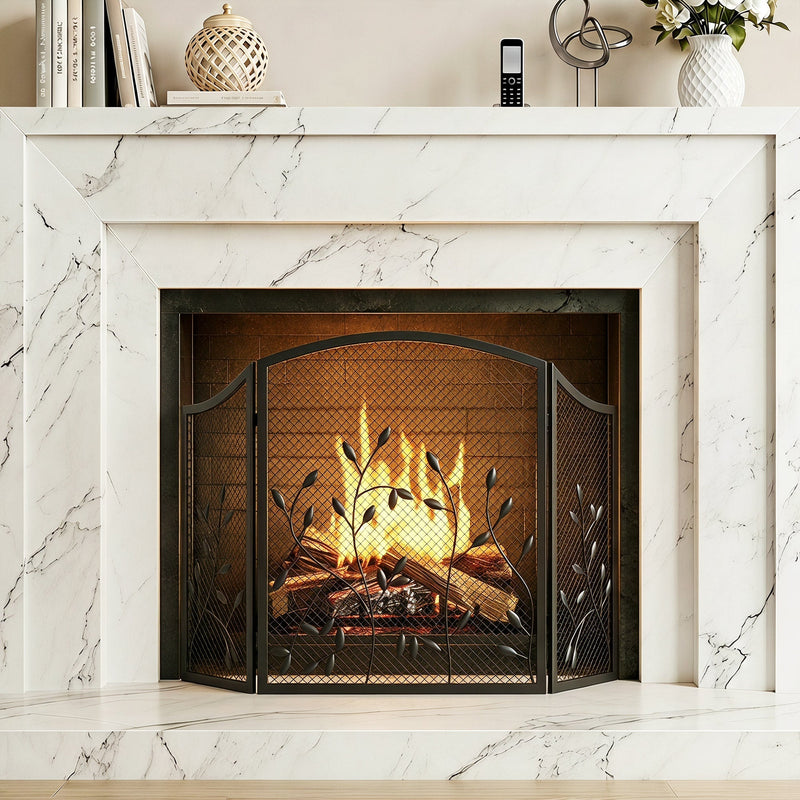 Fireplace screen standing in front of a lit fire in a white marble surround