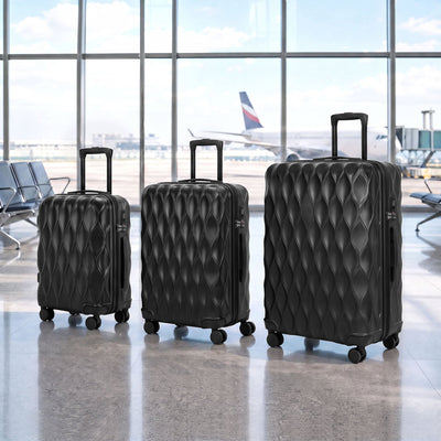 Black suitcase set standing in an airport departure lounge