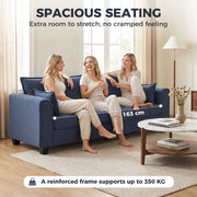 Three people sitting on the dark blue sofa with a 163 cm seat width marked