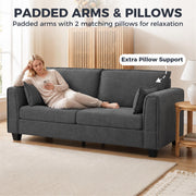Woman lying on the dark grey sofa with padded arms and 2 matching pillows