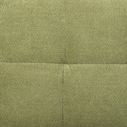 Close-up of the green textured sofa fabric showing the panel seam