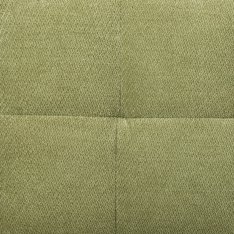 Close-up of the green textured sofa fabric showing the panel seam
