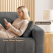 Woman relaxing against the wide armrest of the grey sofa with an extra pillow