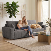 Mother and child reading on the grey sofa next to a golden retriever