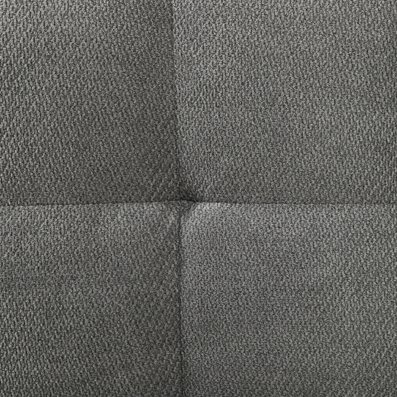 Close-up of the grey textured sofa fabric showing the panel seam