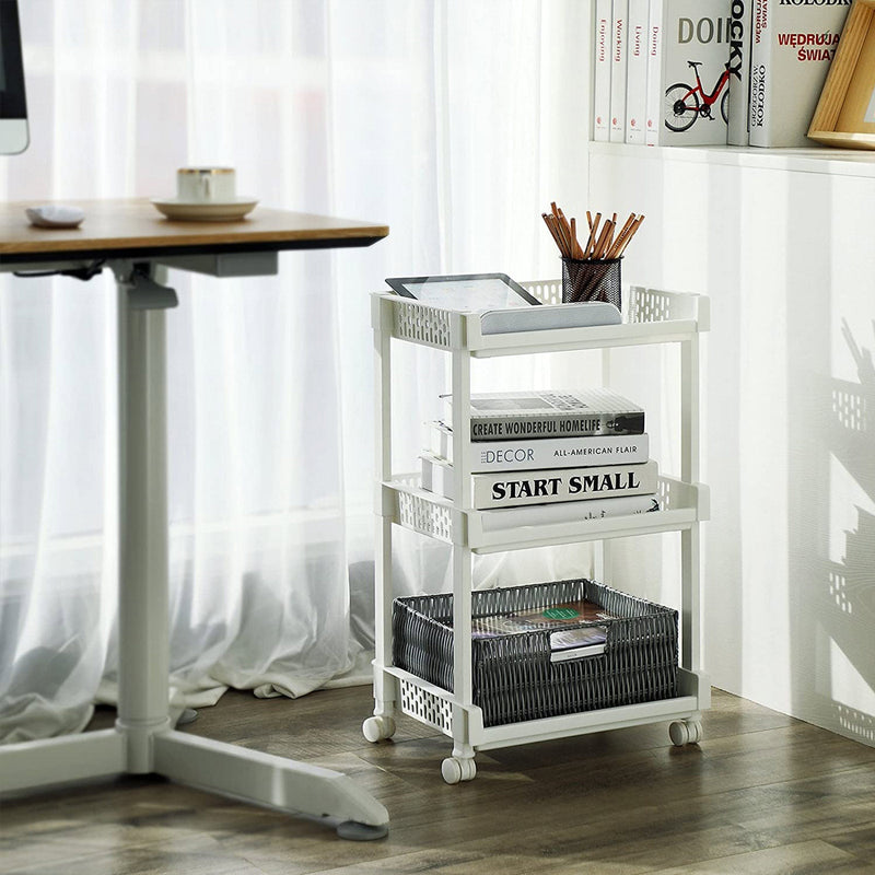 White trolley next to a home office desk holding books, pens and a storage basket