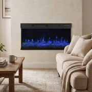 Electric fire with blue flames on a wall above a sofa and coffee table