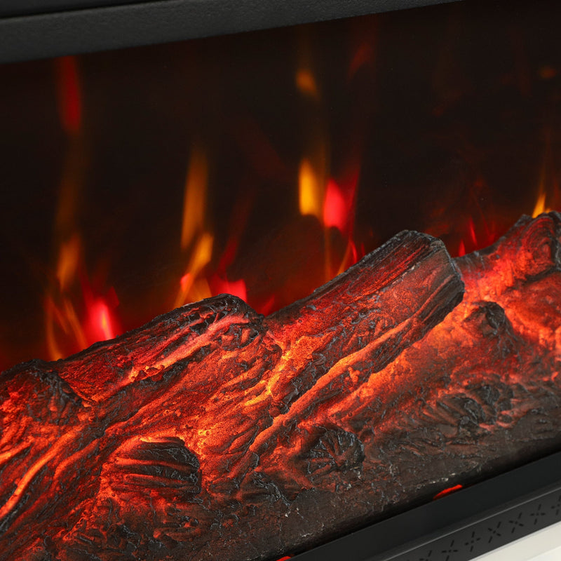 Close-up of orange and red flames glowing over faux logs