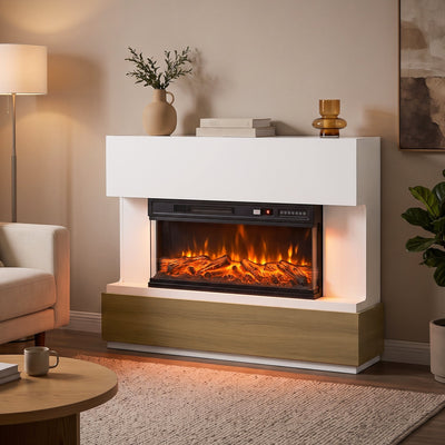 White 3-sided electric fireplace with a wood-tone base in a living room beside a lamp and sofa
