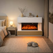 White 3-sided fireplace with a wood-tone base in a bedroom with a cat on the rug