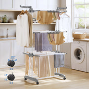White clothes airer in a kitchen with callouts showing 4 castors, 2 with brakes