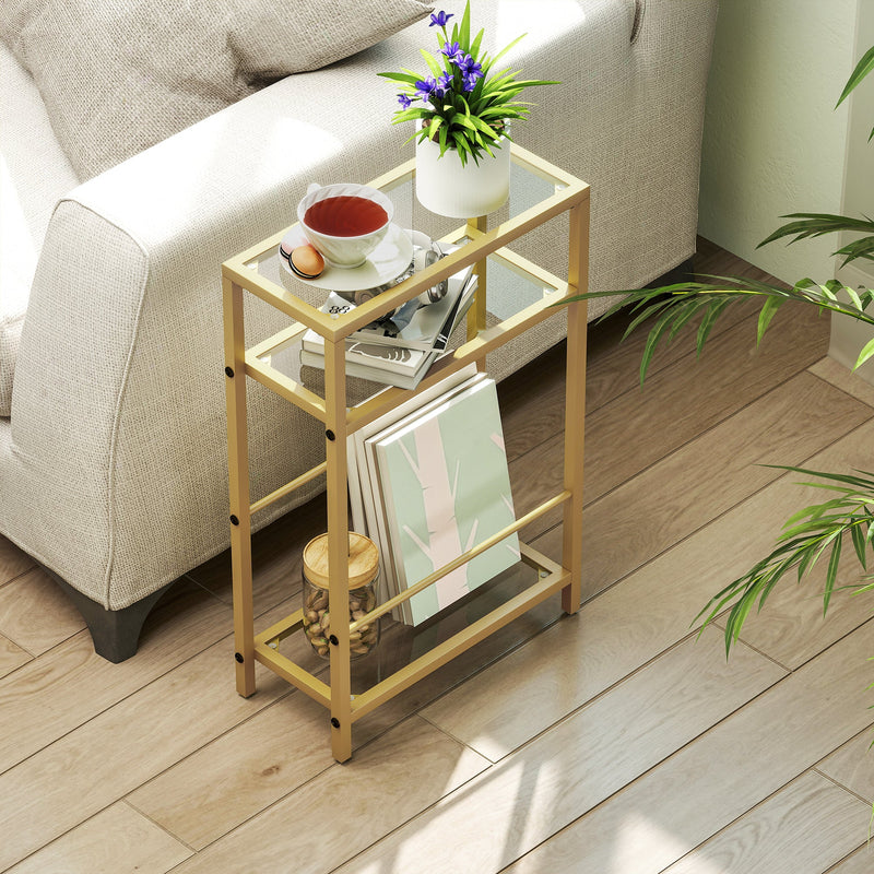 Overhead view of the gold side table beside a sofa styled with tea, books and a plant