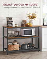 Kitchen island used as a counter extension with a microwave and coffee machine