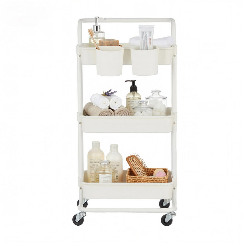 White trolley on a plain background stocked with folded towels, soap bottles and a hairbrush