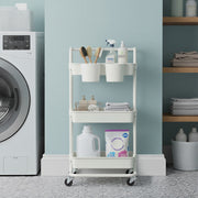 White trolley storing detergent and brushes in a blue laundry room beside a washing machine