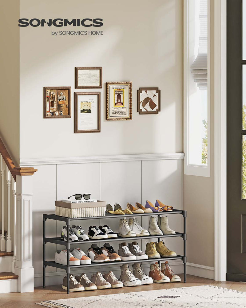 3-tier shoe rack in an entryway below a gallery wall of framed pictures