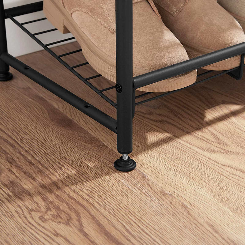 Close up of boots on the wire shelf and the adjustable foot on a wooden floor