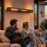 Family relaxing on a sofa under the wall-mounted patio heater at dusk