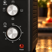 Close-up of the function, temperature and timer knobs and power light