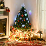 Lit tree in a room corner surrounded by wrapped gifts