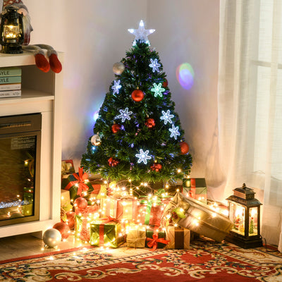 Lit tree in a room corner surrounded by wrapped gifts